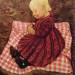 Peasant child in red-checked pillow